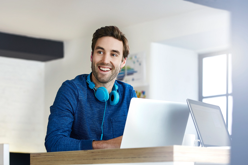 Male office worker with headphones