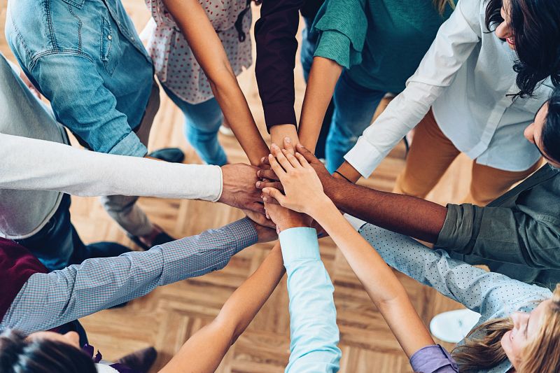 office worker hands together for team building