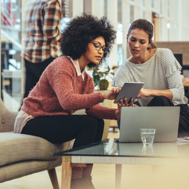 two women in office on tablet