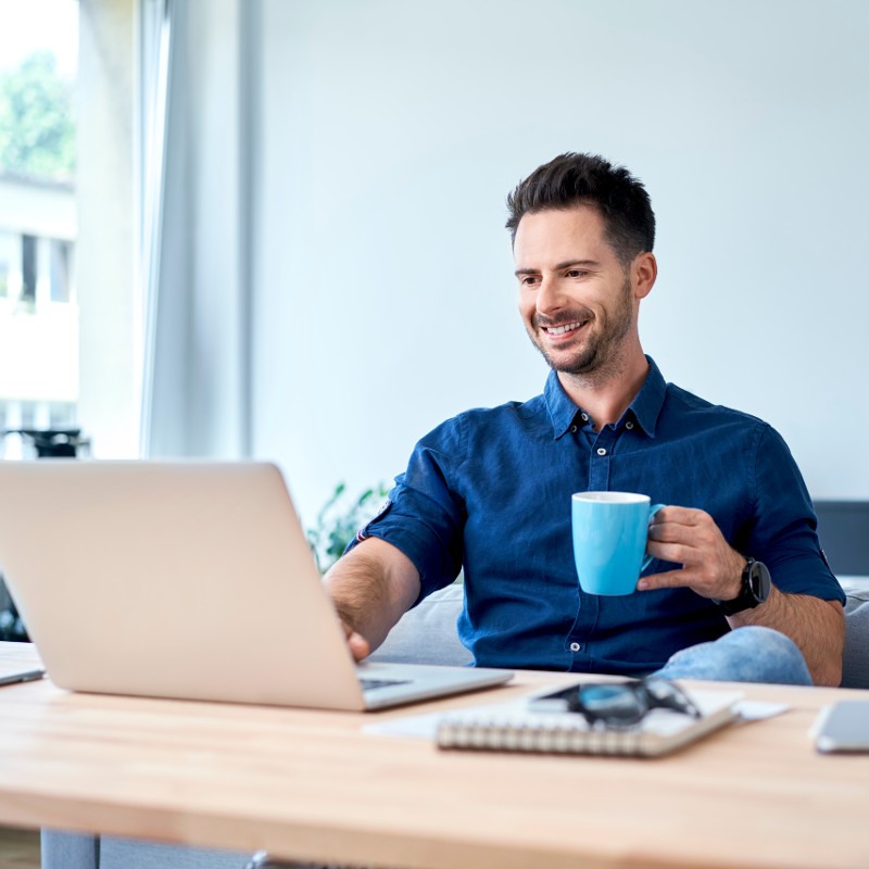 man drinking coffee from blue mug