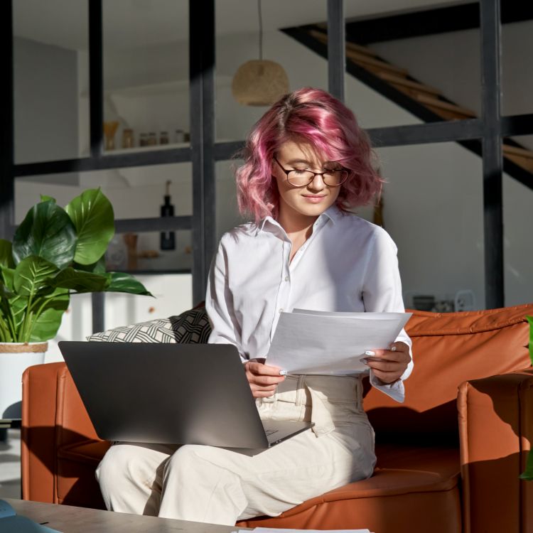 Woman with laptop and documents