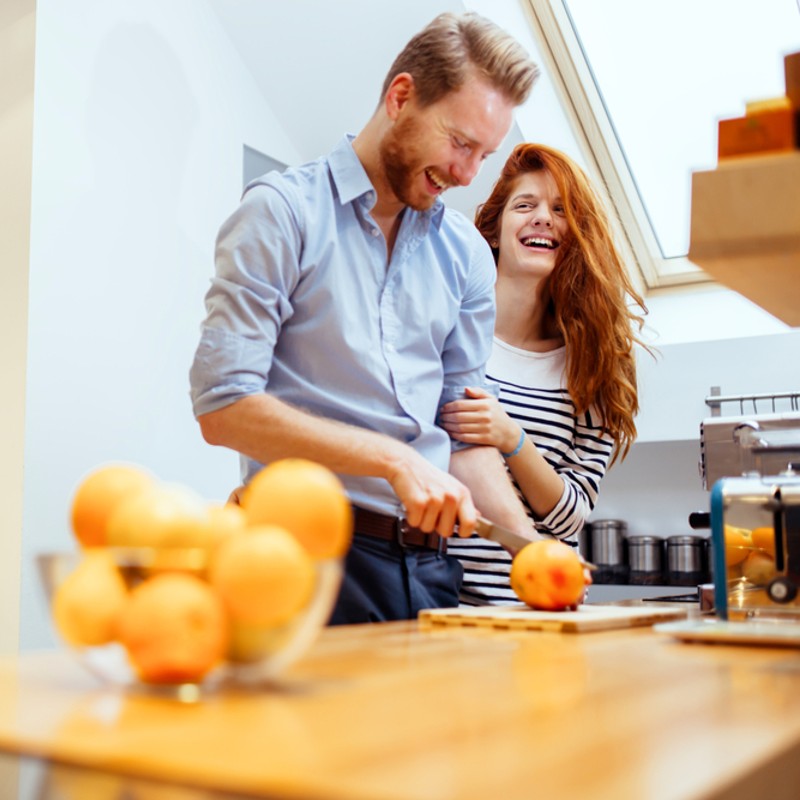 young couple at home cooking