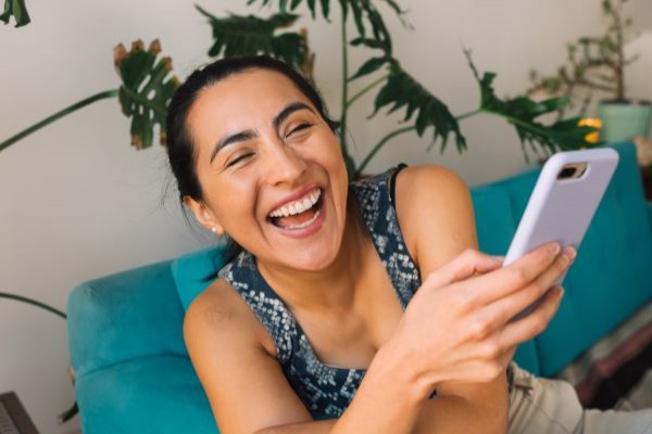 woman with phone laughing