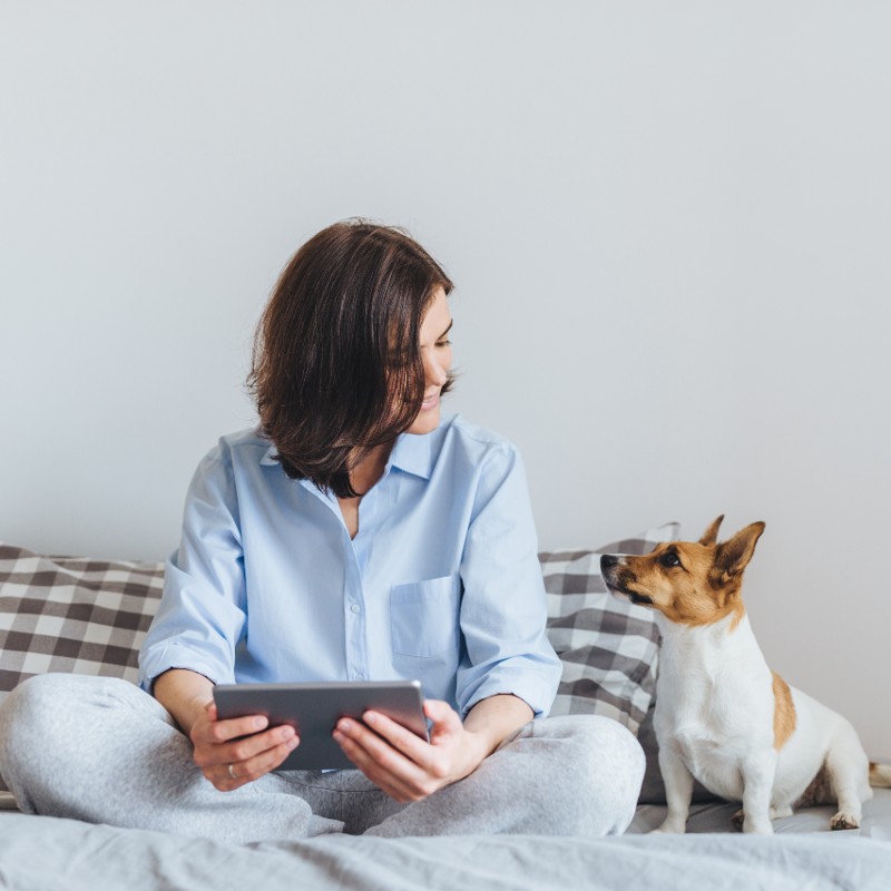 woman in bed with dog