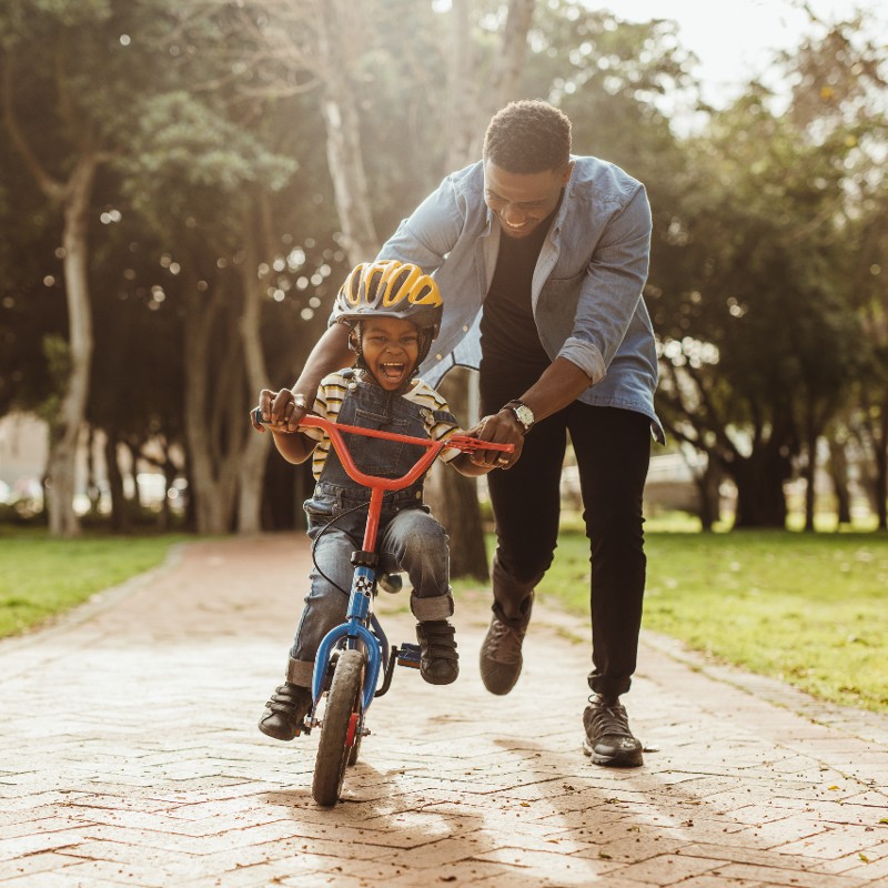 father with son on bike