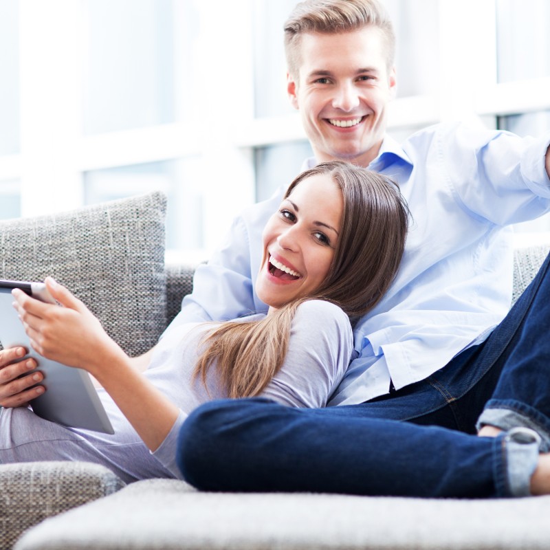 young couple at home on laptop