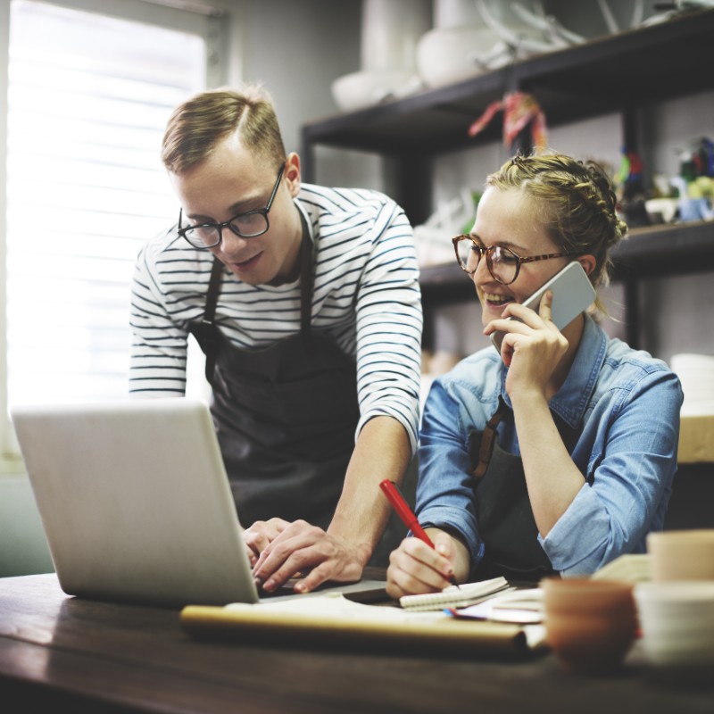 young couple in office on phone