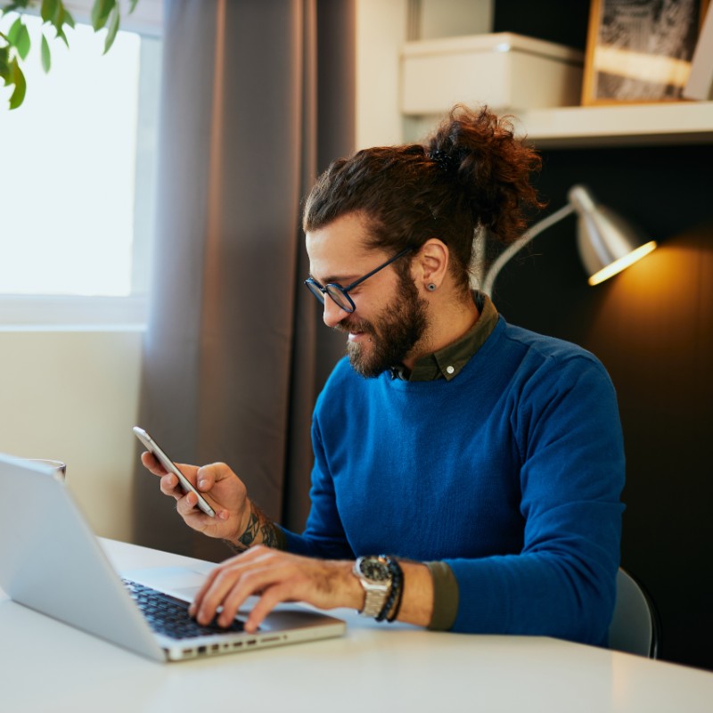 man on laptop and mobile