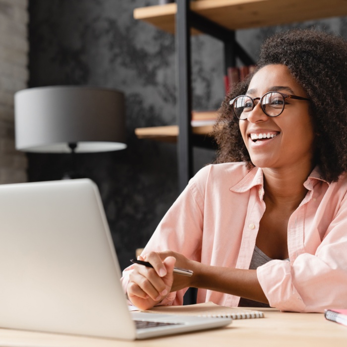 young woman at desk on laptop