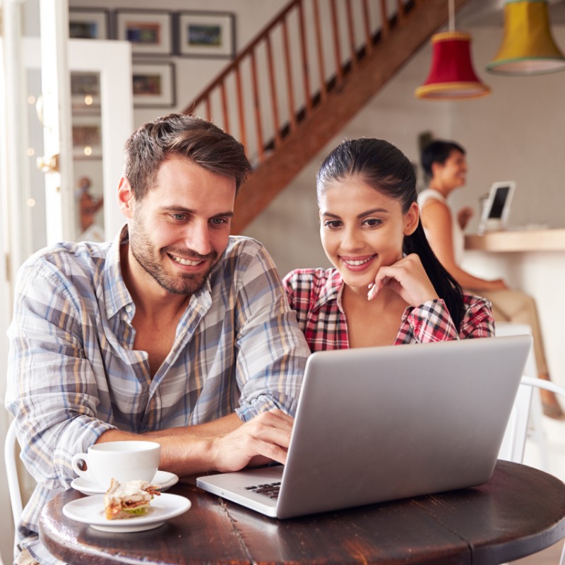 young couple in coffee shop on laptop