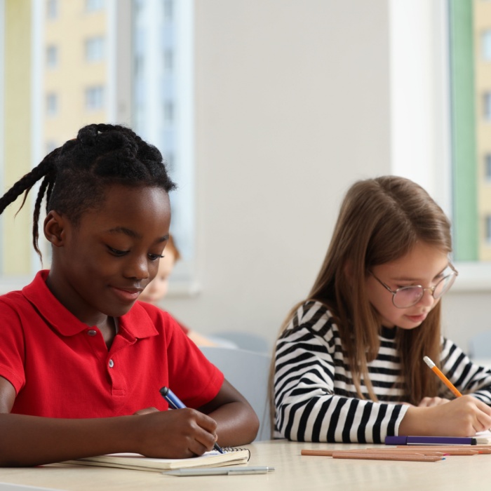 two school kids doing school work