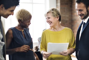 older woman talking to work colleagues