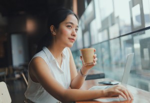 woman in coffee shop on laptop